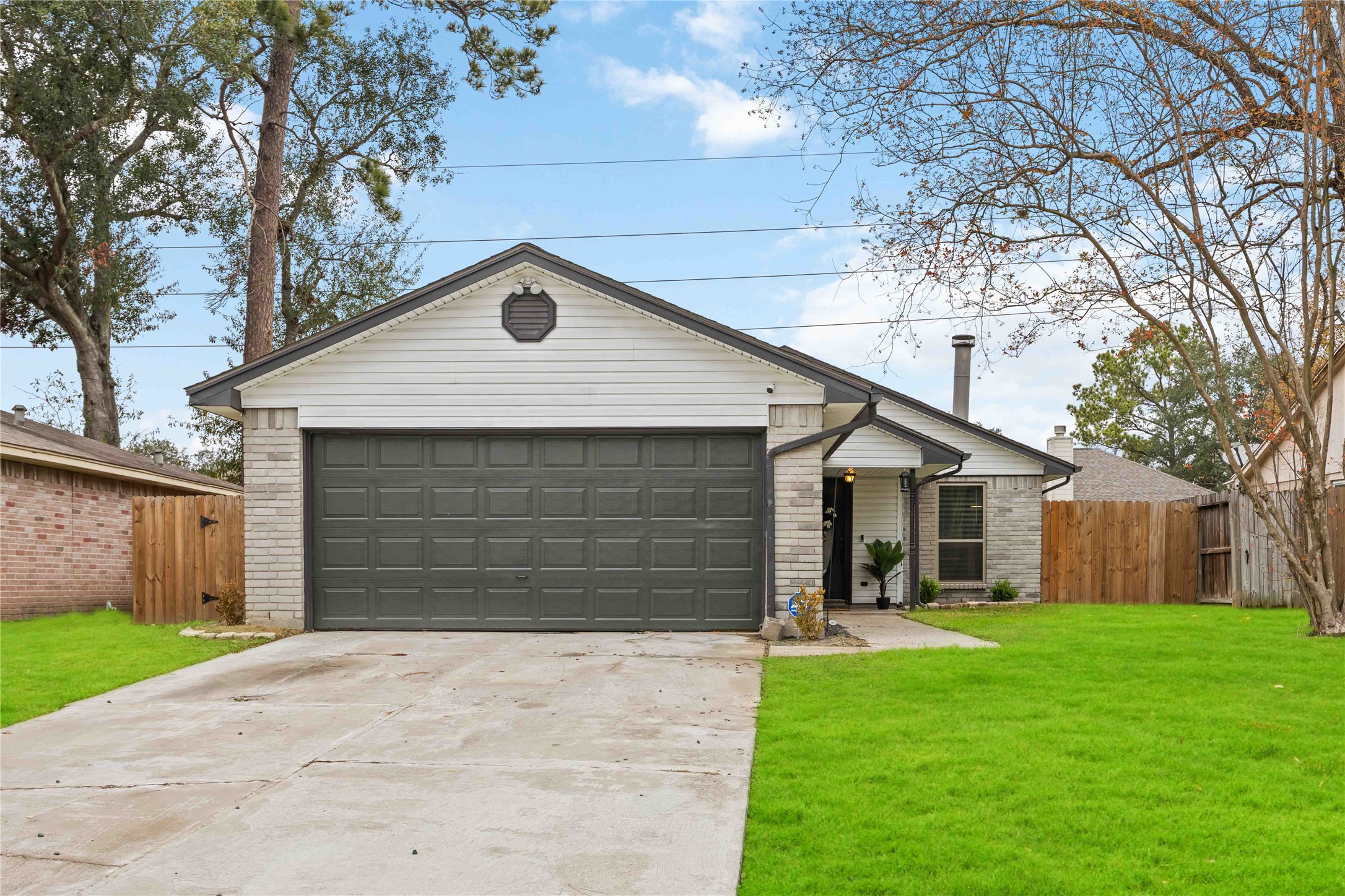 4811 Tealgate Drive Spring, TX 77373 - Photo 2 of 25 a front view of a house with a yard and garage