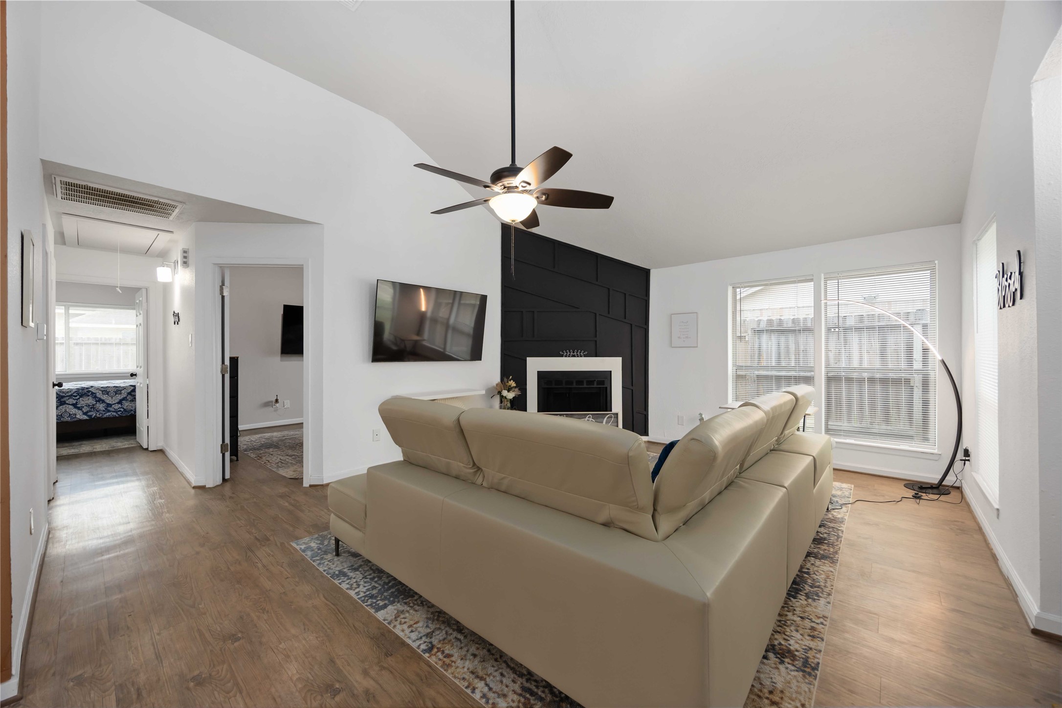 4811 Tealgate Drive Spring, TX 77373 - Photo 7 of 25 a living room with furniture a ceiling fan a flat screen tv and a large window