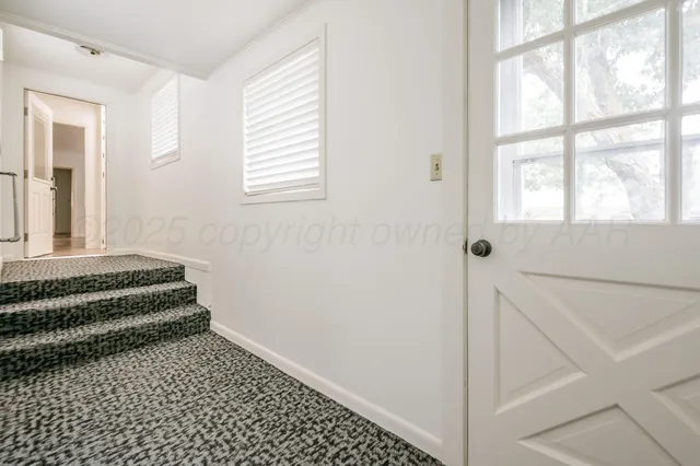 a bathroom with a window and a bathtub