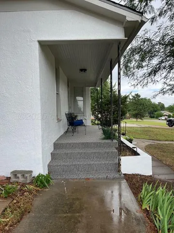 a view of a patio with table and chairs potted plants with wooden floor