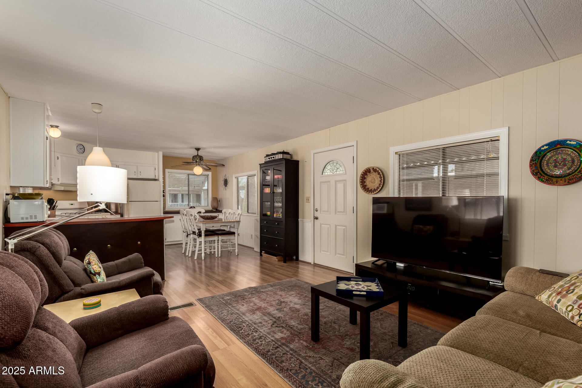 11425 East University Drive, Unit 53 Apache Junction, AZ 85120 - Photo 1 of 29 a living room with furniture and a flat screen tv