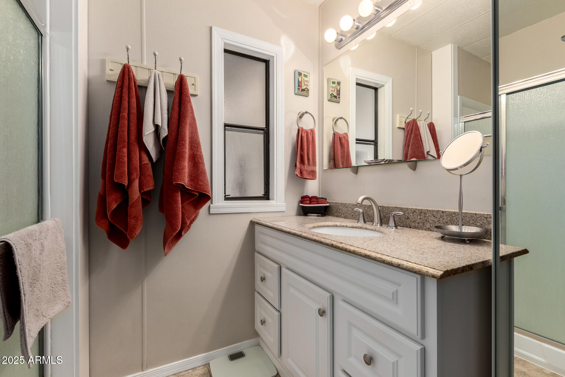 11425 East University Drive, Unit 53 Apache Junction, AZ 85120 - Photo 13 of 29 a bathroom with a sink vanity and mirror