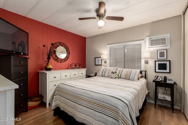 a bedroom with a bed and a flat screen tv