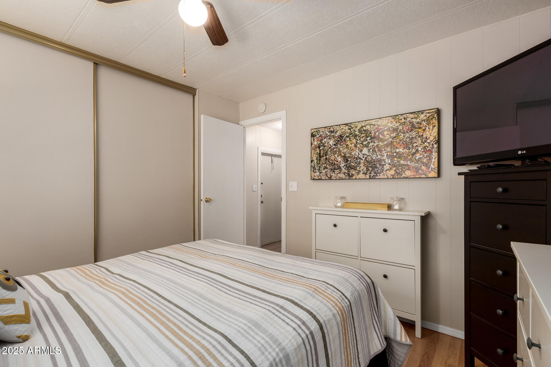 11425 East University Drive, Unit 53 Apache Junction, AZ 85120 - Photo 15 of 29 a bedroom with a bed and a flat screen tv