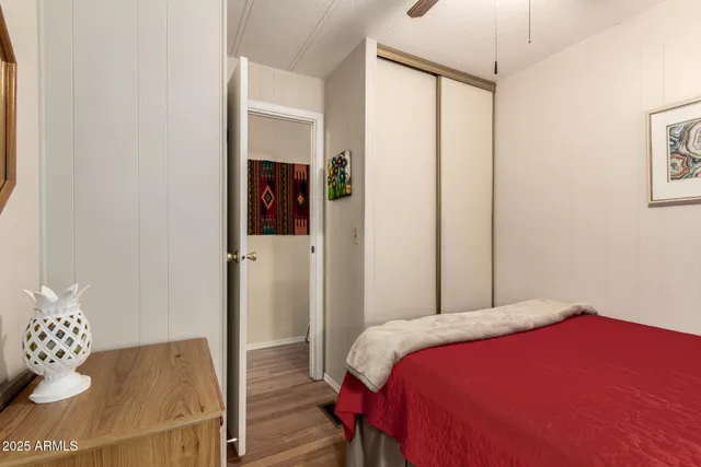 a bedroom with a bed and a mirror