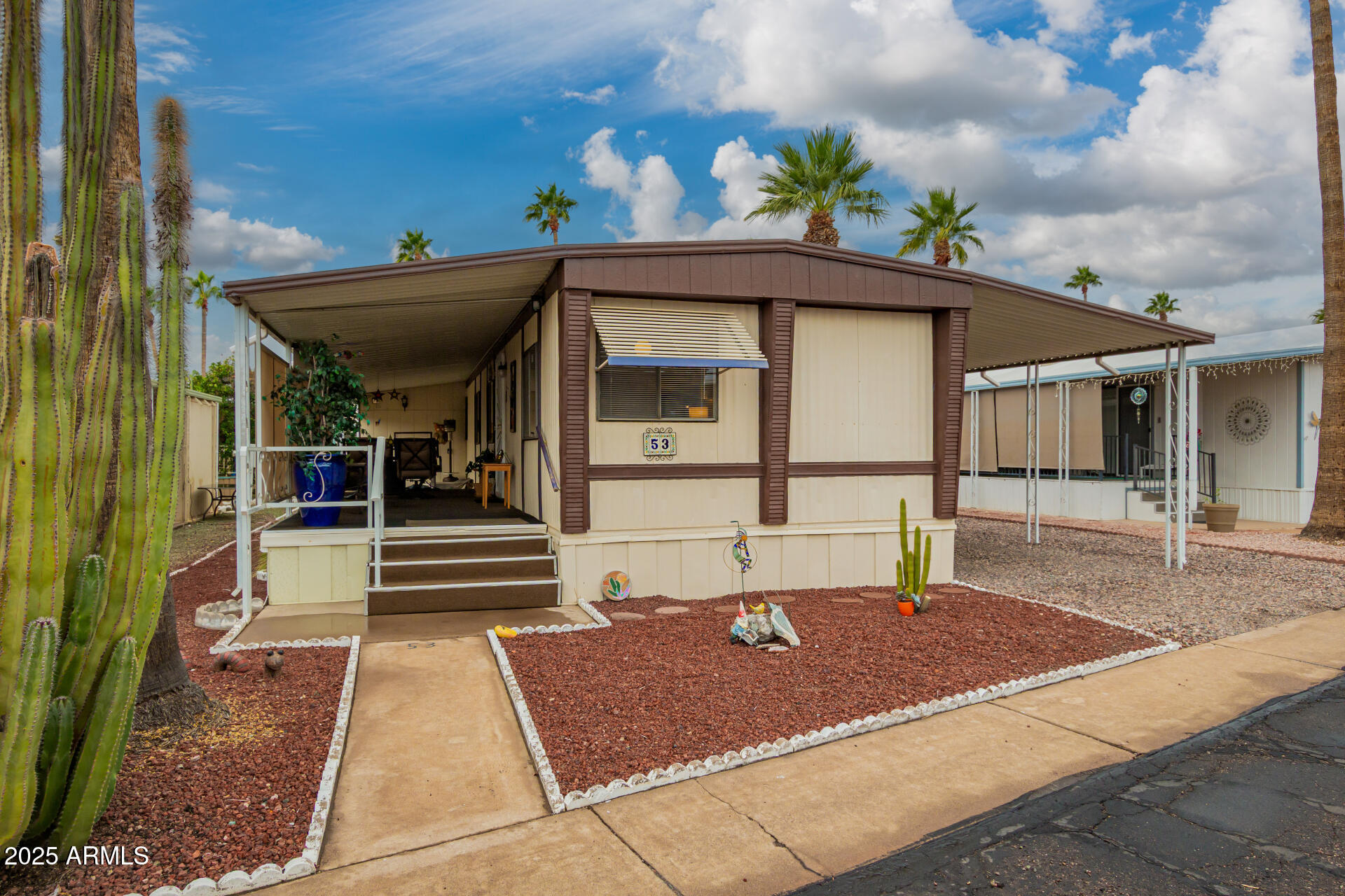 11425 East University Drive, Unit 53 Apache Junction, AZ 85120 - Photo 2 of 29 a front view of a house with a porch