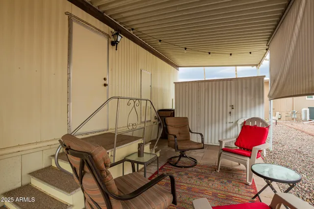 a view of a patio with table and chairs with wooden floor