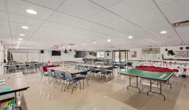 a living room with furniture and view of kitchen