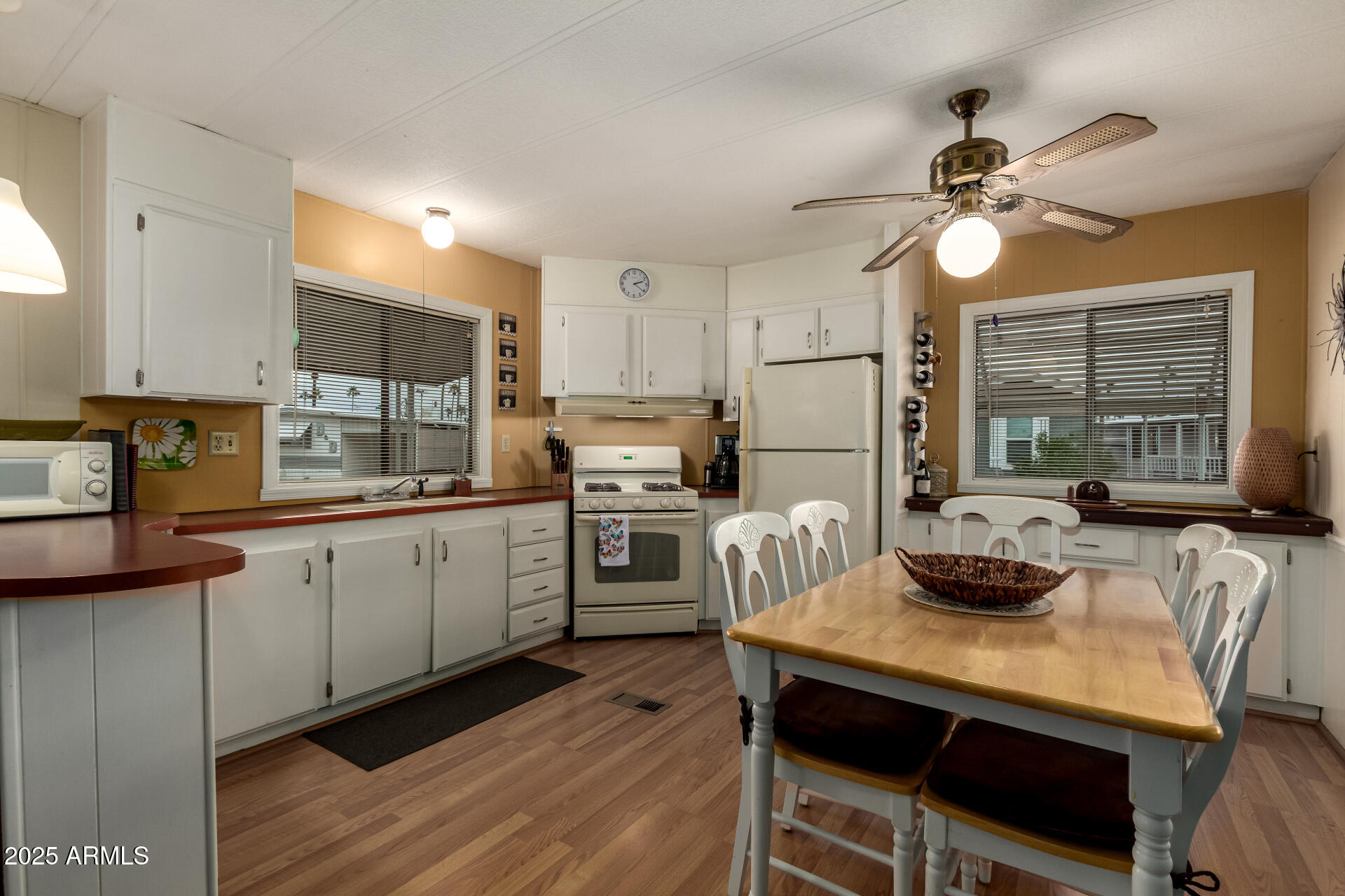 11425 East University Drive, Unit 53 Apache Junction, AZ 85120 - Photo 7 of 29 a kitchen with a table chairs stove and cabinets