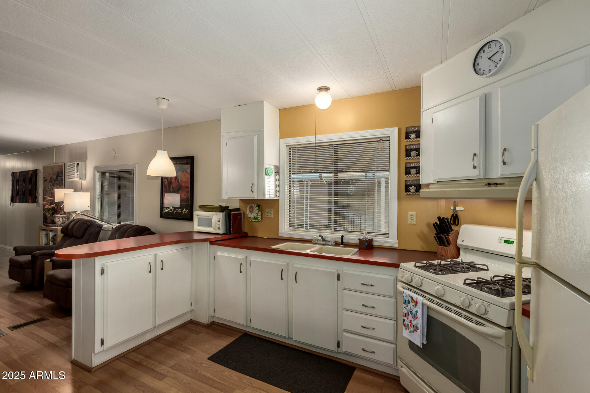 11425 East University Drive, Unit 53 Apache Junction, AZ 85120 - Photo 9 of 29 a kitchen with a sink stove and cabinets