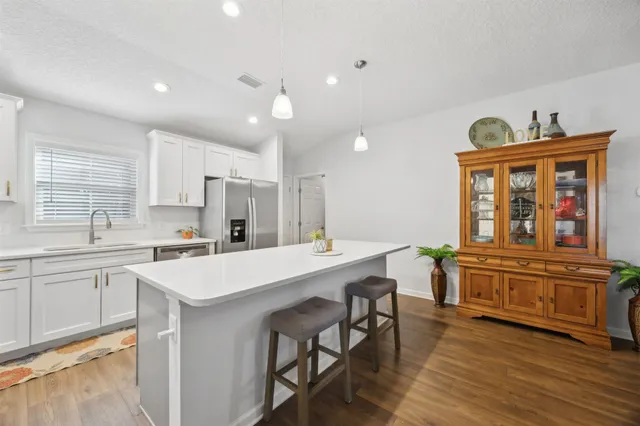 a kitchen with a stove a sink and a refrigerator