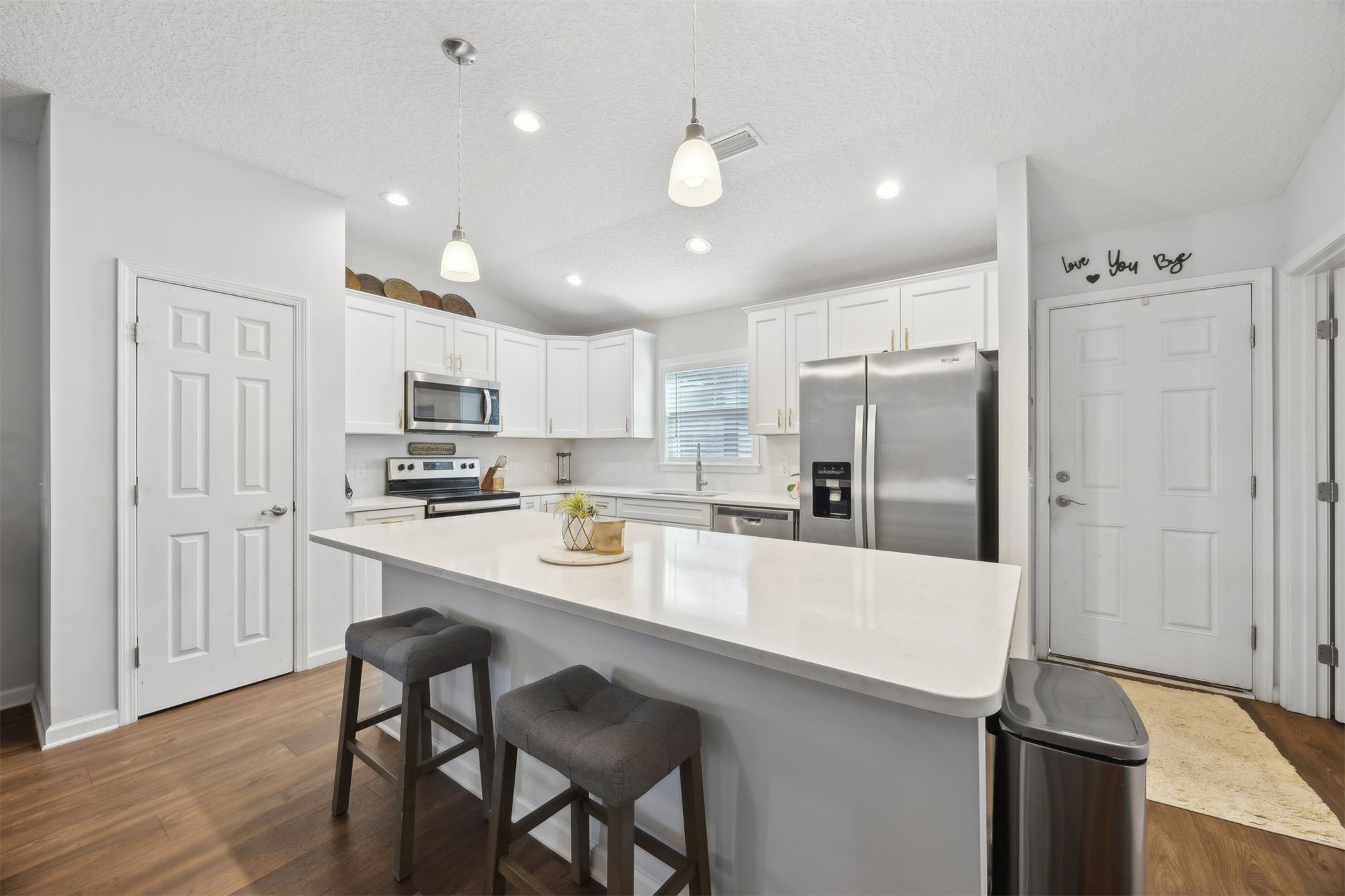 45480 Musslewhite Road Callahan, FL 32011 - Photo 2 of 31 a kitchen with stainless steel appliances a refrigerator stove microwave and cabinets