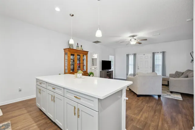 a view of living room with furniture and wooden floor