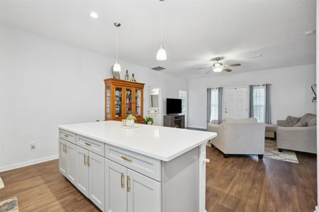 a view of living room with furniture and wooden floor