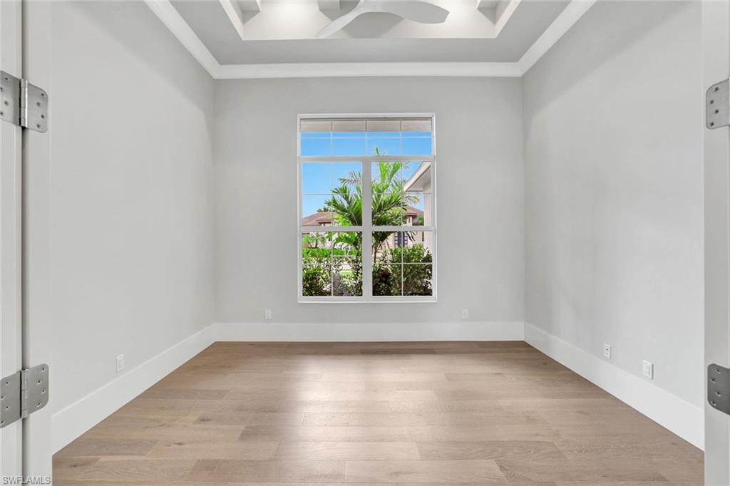 14286 Charthouse Circle Naples, FL 34114 - Photo 18 of 47 Empty room with crown molding, light wood finished floors, and a ceiling fan