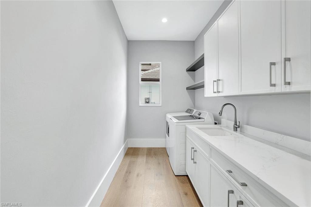 14286 Charthouse Circle Naples, FL 34114 - Photo 27 of 47 Laundry area with light wood finished floors, cabinet space, separate washer and dryer, and recessed lighting