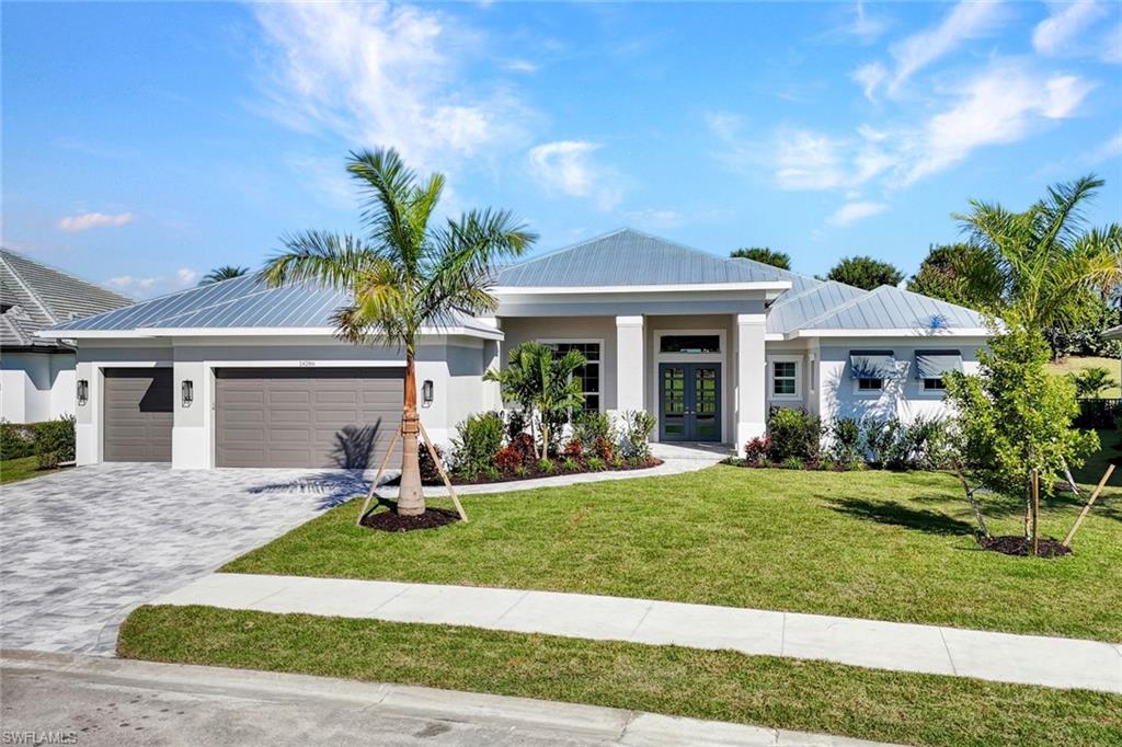 14286 Charthouse Circle Naples, FL 34114 - Photo 33 of 47 View of front facade with a front yard, decorative driveway, stucco siding, a garage, and french doors
