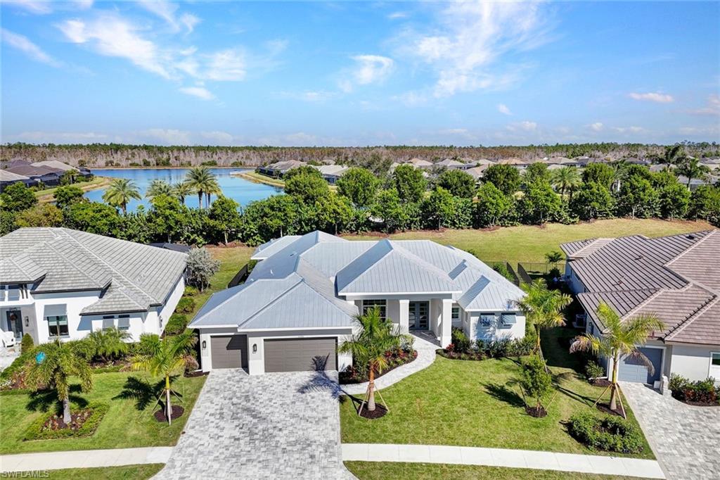 14286 Charthouse Circle Naples, FL 34114 - Photo 36 of 47 Aerial perspective of suburban area with a large body of water and a tree filled landscape