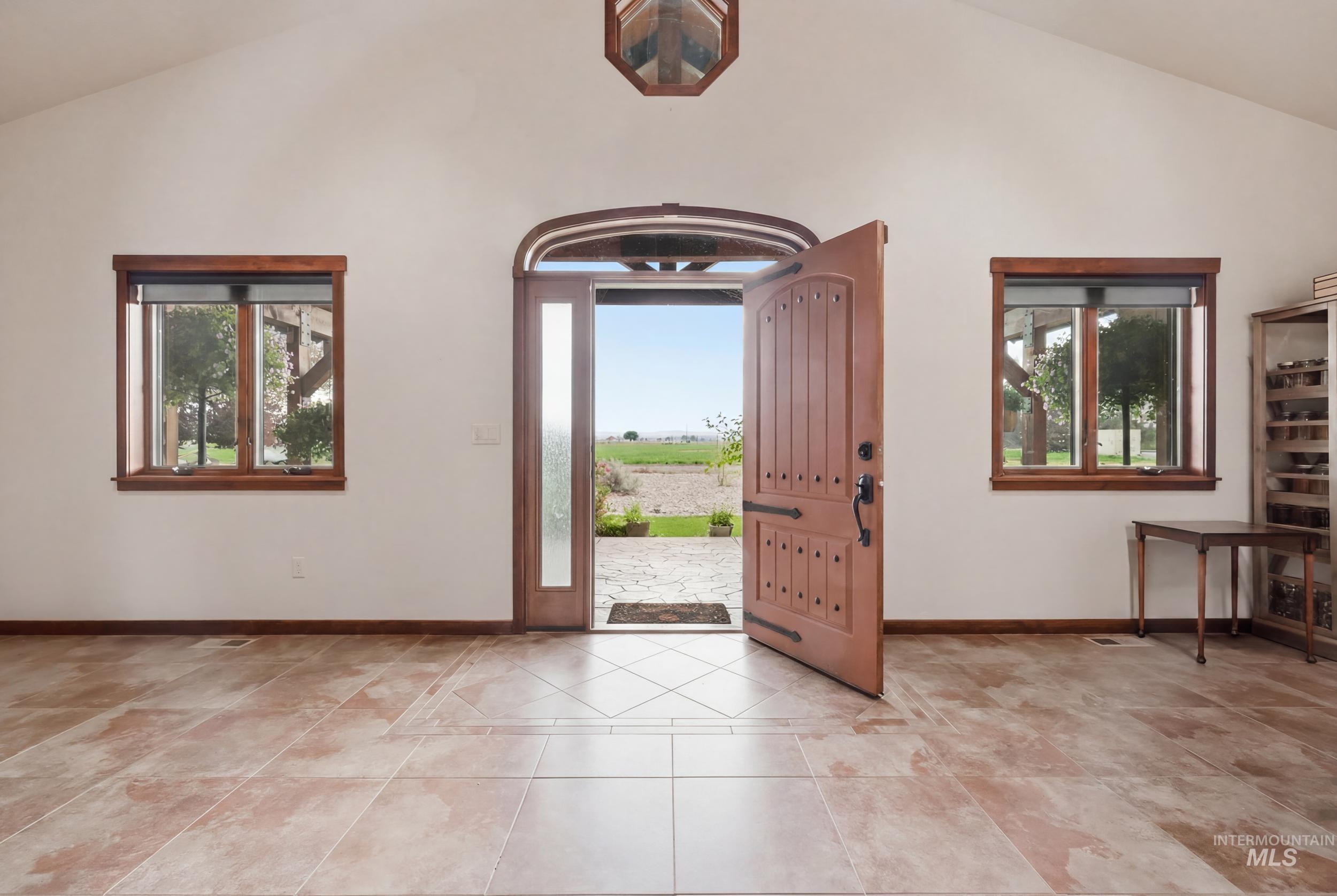 339 Airport Road Weiser, ID 83672 - Photo 5 of 49 Vaulted entry with wood-paneled door, side light, and arched transom