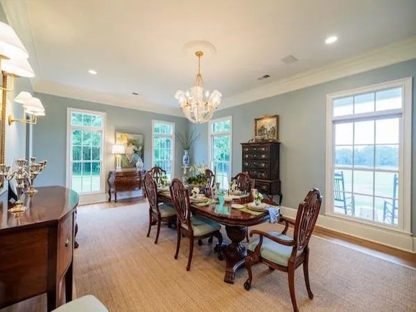 a living room with fireplace furniture and a chandelier