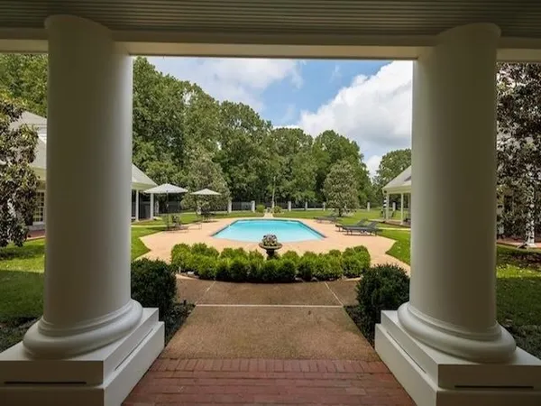 a view of a swimming pool with a yard