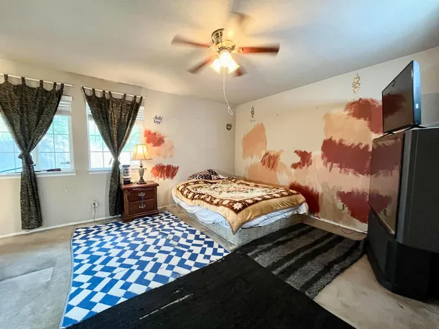 a bedroom with a bed and a chandelier