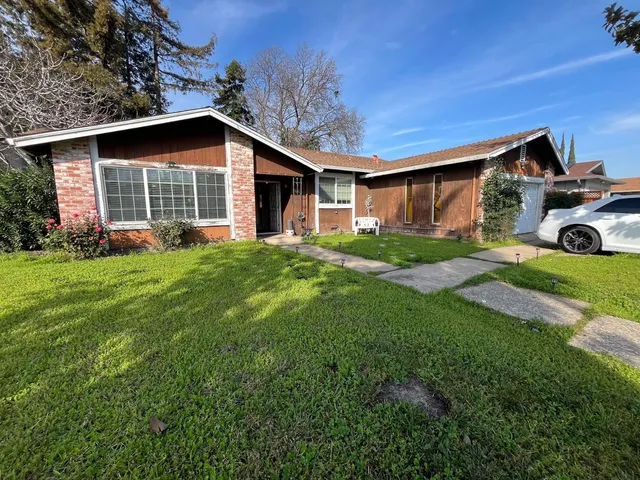 a front view of house with yard and green space