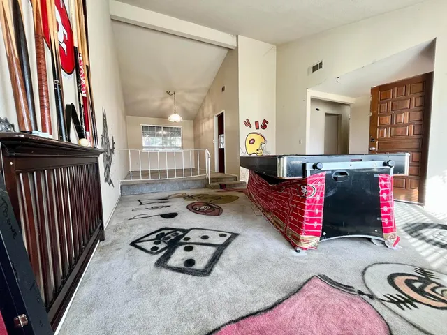 a living room with furniture and a book shelf