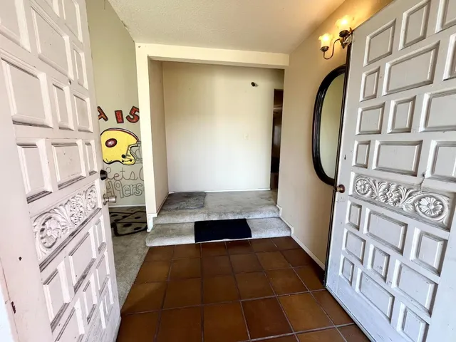 a view of an entryway with wooden floor