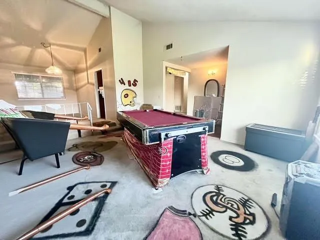 a living room with furniture a flat screen tv and a table