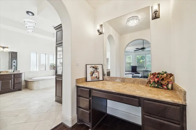a bathroom with a granite countertop sink a toilet and bathtub