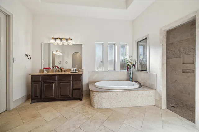 a bathroom with a sink a toilet a mirror and shower