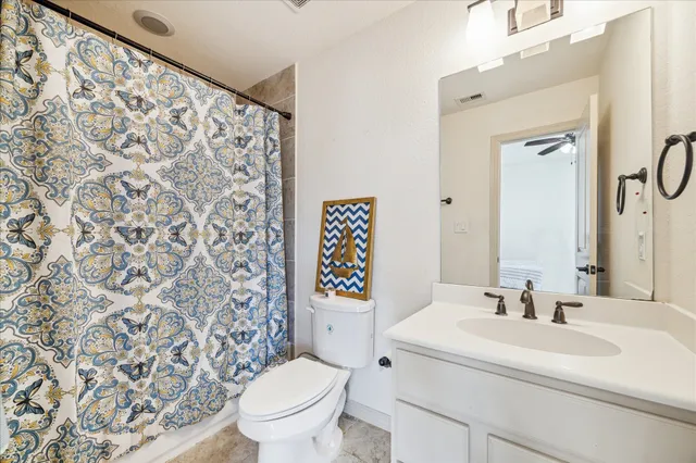 a bathroom with a sink toilet and a mirror
