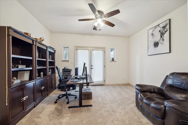a view of a livingroom with workspace and a couch
