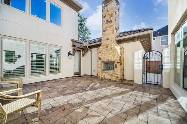a view of a house with backyard porch and sitting area