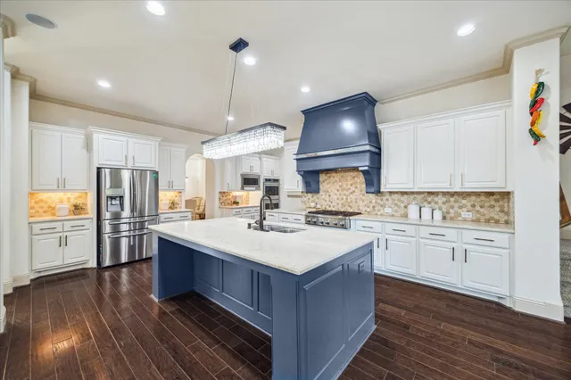 a kitchen with a sink stove and refrigerator