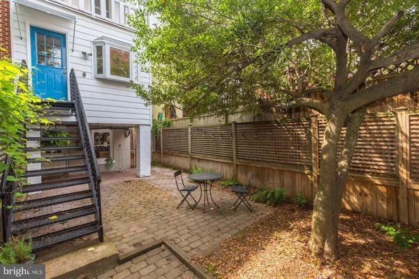 a view of chair and table in the backyard