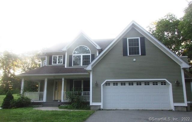 a front view of a house with a garden and plants