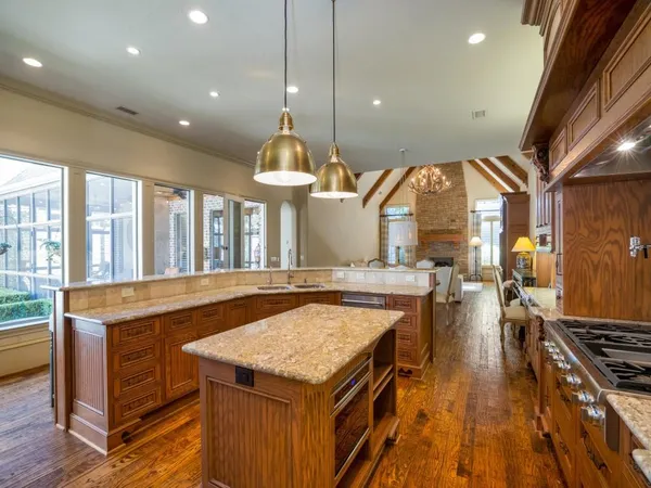 a kitchen with a stove and a wooden floor
