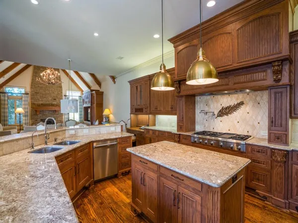 a kitchen with a stove a sink and a refrigerator