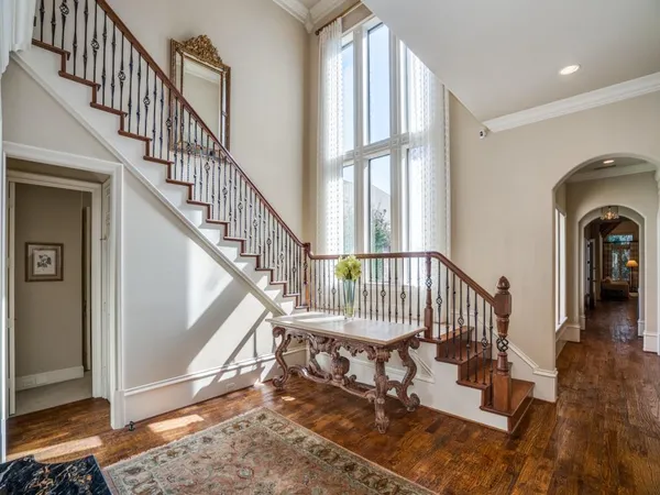 a view of entryway and hall with wooden floor