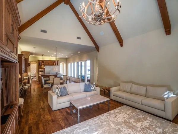 a living room with furniture and a chandelier