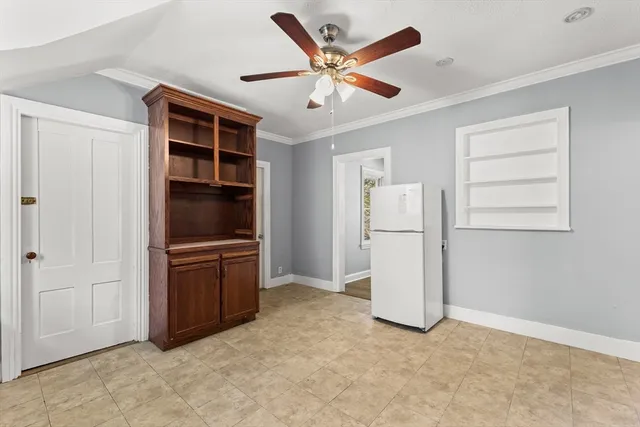 an empty room with closet and windows