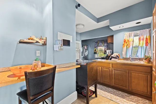 a kitchen with a table chairs and a sink