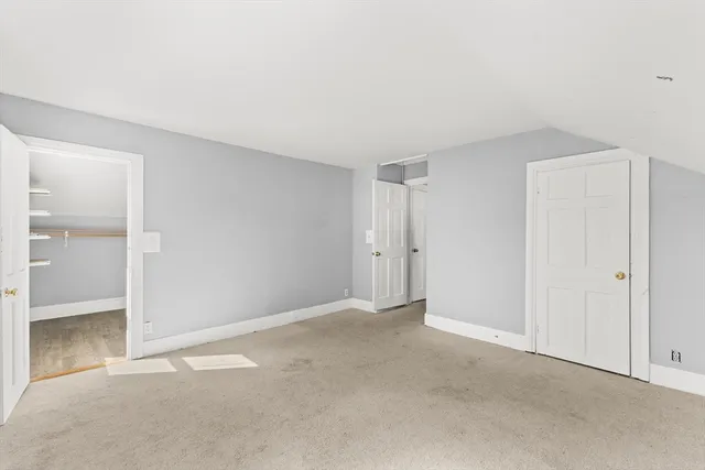 a view of an empty room and closet area