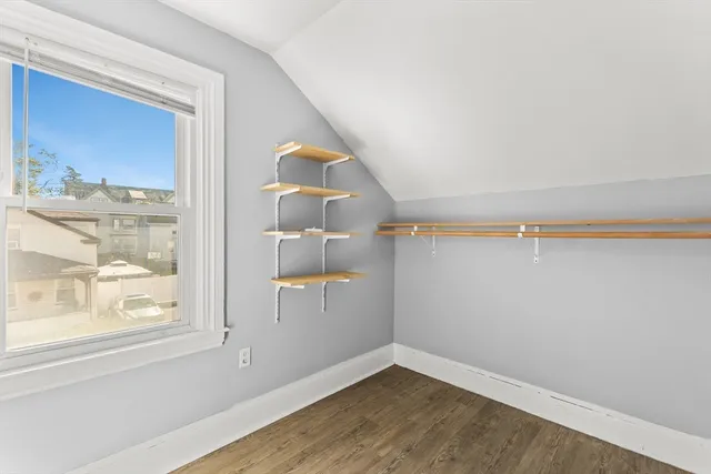 a view of a small space with wooden floor and a window