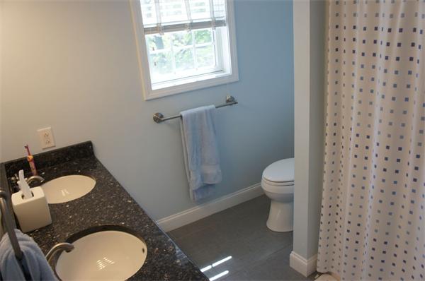 7 Pheasant Road Needham, MA 02492 - Photo 8 of 20 a bathroom with a granite countertop toilet and a sink
