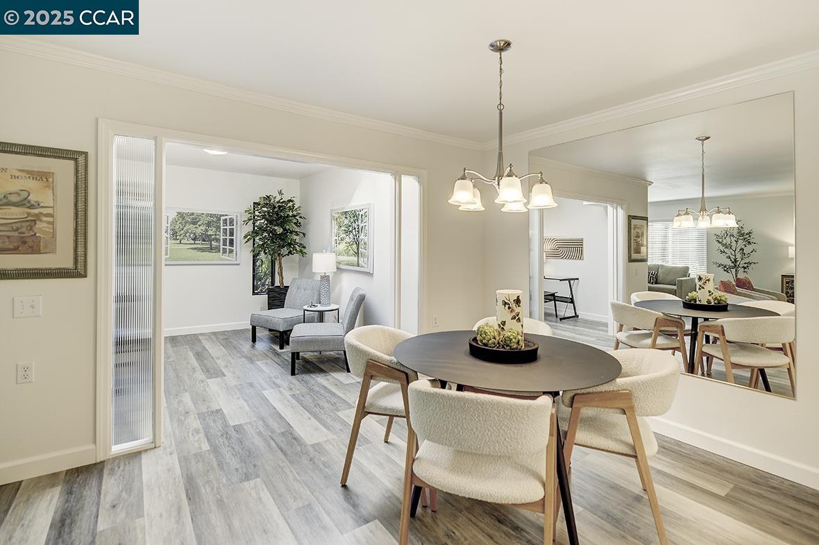 1315 Golden Rain Road, Unit 2 Walnut Creek, CA 94595 - Photo 11 of 54 a dining room with furniture a chandelier and wooden floor