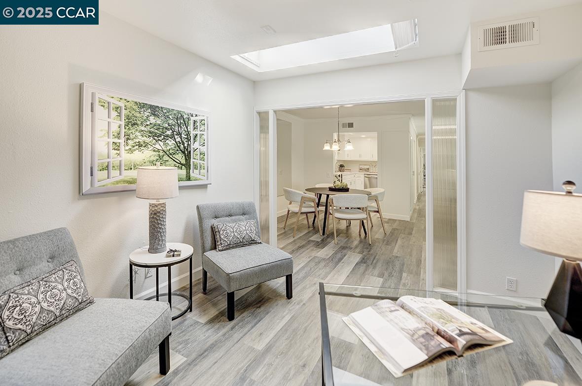 1315 Golden Rain Road, Unit 2 Walnut Creek, CA 94595 - Photo 13 of 54 a living room with furniture and a table