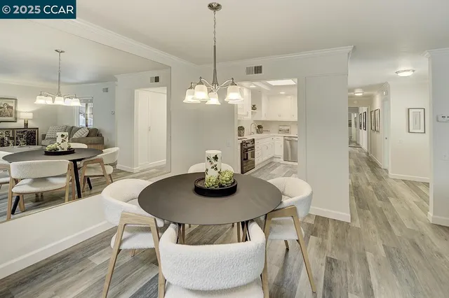 a kitchen with cabinets appliances and wooden floor